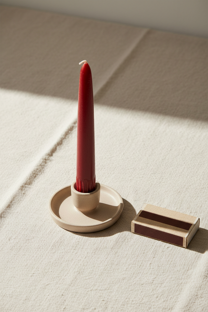 Get What You Want ritual candle - brick red 7-inch taper candle on linen cloth with matchbox for scale