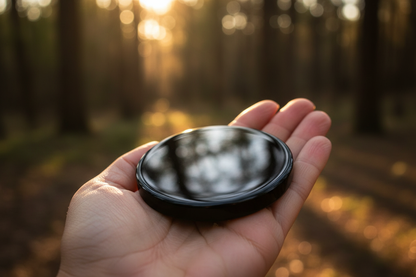 Black Obsidian Scrying Mirror 3 inch held in open palm showing true scale
