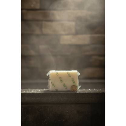 Ohli~Way Coconut Spiritual Cleansing Soap 100g bar on wet dark stone shower ledge with water droplets and soft steam