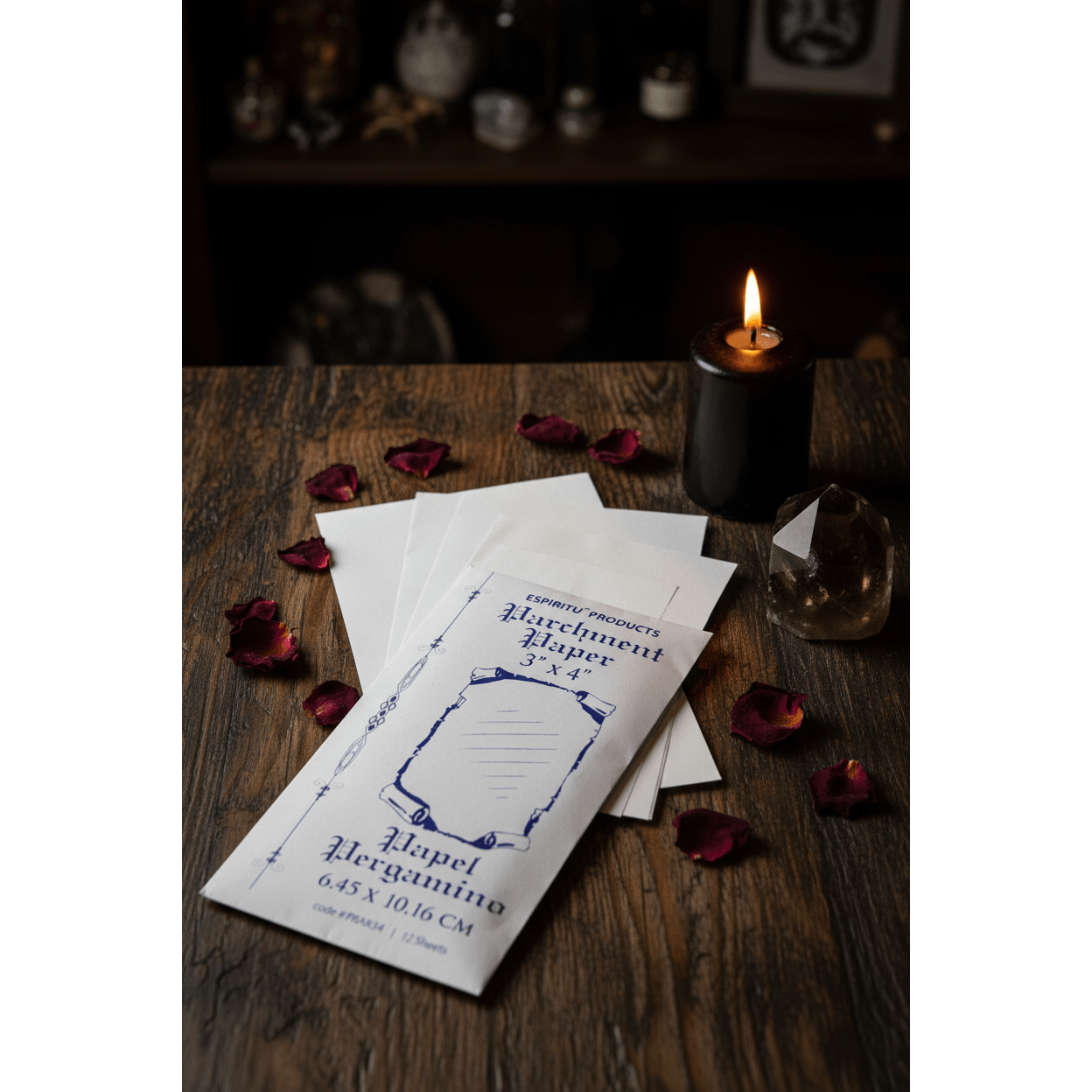 3" x 4" parchment paper sheets by Espiritu with matching envelope beside a black taper candle, dried rose petals, and smoky quartz on a dark wooden altar