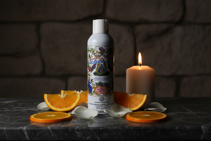 Florida Water Spray 8oz on dark marble altar with orange slices, rose petals, and candlelight