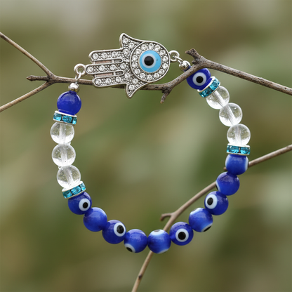 Evil Eye Clear Quartz Bracelet hanging from dried eucalyptus branch botanical macro