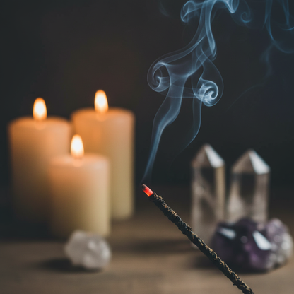 Close-up of lavender incense stick glowing ember with smoke in meditation space