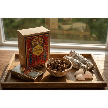 Frankincense backflow cones in a ceramic bowl on a rustic wooden tray with sage and rose quartz in golden sunlight