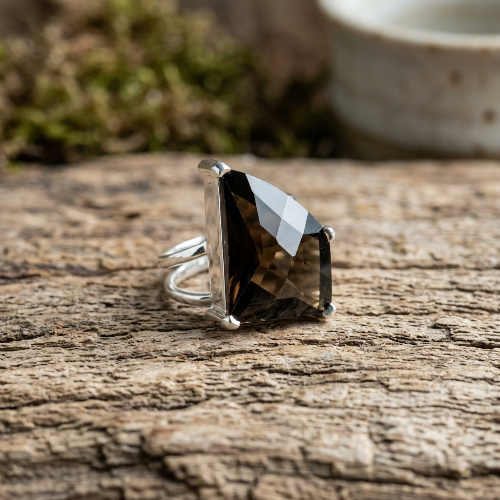 Detailed close-up of size 8 Smokey Quartz ring showcasing facets on a natural wooden surface with soft lighting.