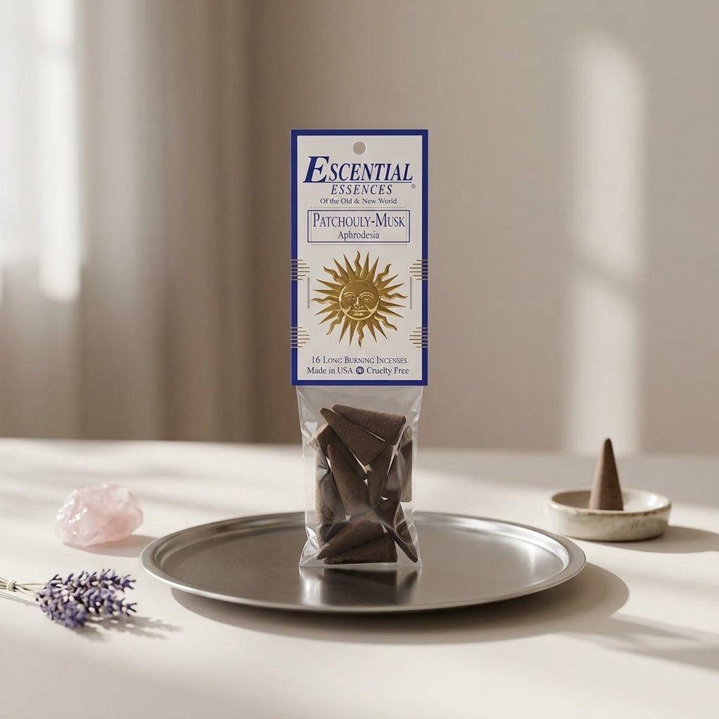 Petite incense cone on a reflective metal dish in a modern ritual altar setup for meditation and romance.