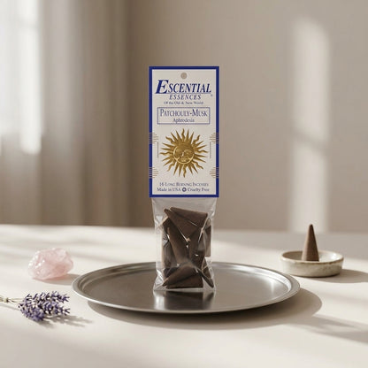 Petite incense cone on a reflective metal dish in a modern ritual altar setup for meditation and romance.