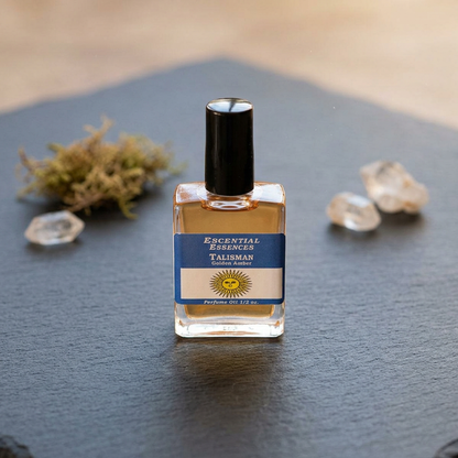 Photorealistic image of a 1/2oz Talisman essences oil bottle on dark stone surface, surrounded by moss and crystals, emphasizing clarity and mystical ambiance.