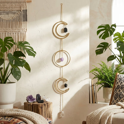 Artistic scene of the triple moon wreath hanging in a bohemian-style room with plants and textiles, emphasizing textures and peaceful decor.