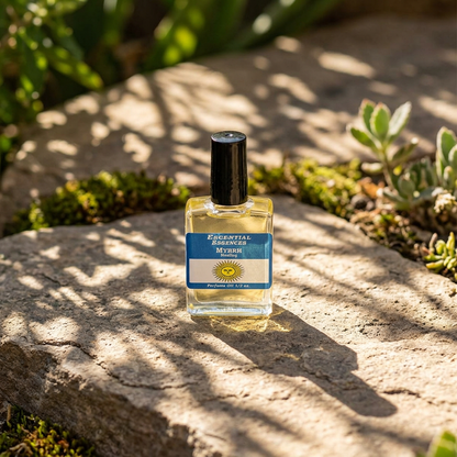 Full-body scene of Myrrh Perfume Oil bottle outdoors on a stone slab, surrounded by greenery and dappled sunlight, emphasizing natural clarity and healing qualities.
