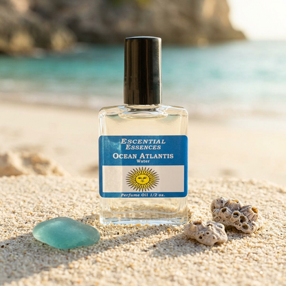 Perfume oil bottle on sandy surface with warm sunlight, highlighting ocean-inspired design.