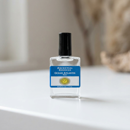 Close-up of Ocean Atlantis Perfume Oil bottle on white gradient surface with diffuse indoor lighting.