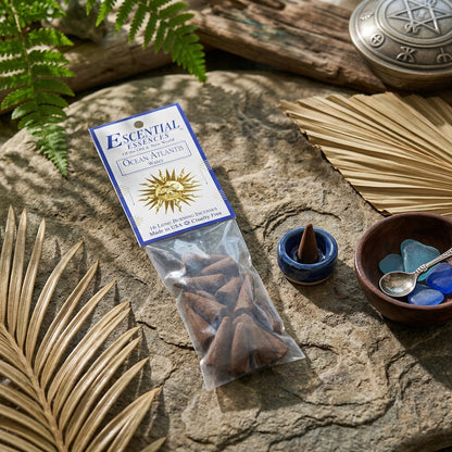 Close-up of Ocean Atlantis incense cone on textured stone surface, illuminated by natural sunlight with greenery background.
