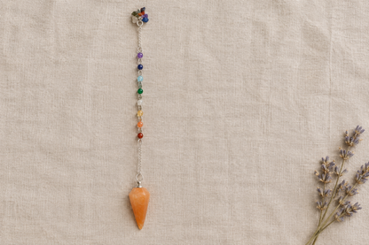 Orange pendulum flat lay