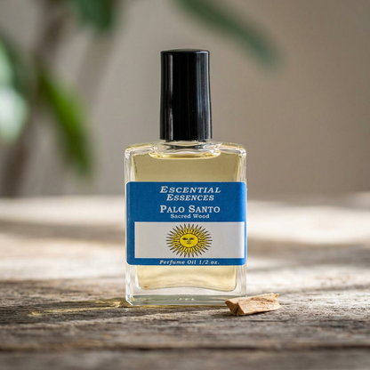Macro shot of Palo Santo Perfume Oil by Escential Essences, showcasing the clear glass bottle on a rustic wooden surface with natural light highlighting details.