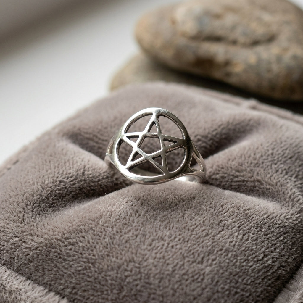 Small silver-plated brass pentagram ring size 8 on a velvet cushion, evoking a peaceful, spiritual vibe with detailed surface micro-texture.