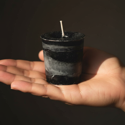 Protection Herbal Votive - Black, held in hand