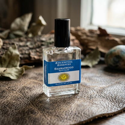 Side view of Shamanwood Perfume Oil on textured leather surface, emphasizing label micro-texture and metallic cap with natural light.