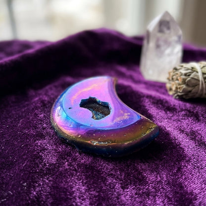 Close-up of a small Moon Rainbow Druse Agate Geode with rainbow hues on velvet, highlighting intricate banding and crystalline details.