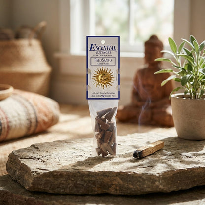 Tiny Palo Santo incense cone placed on a rustic stone surface, with a blurred ritual space in the background, ideal for meditation.