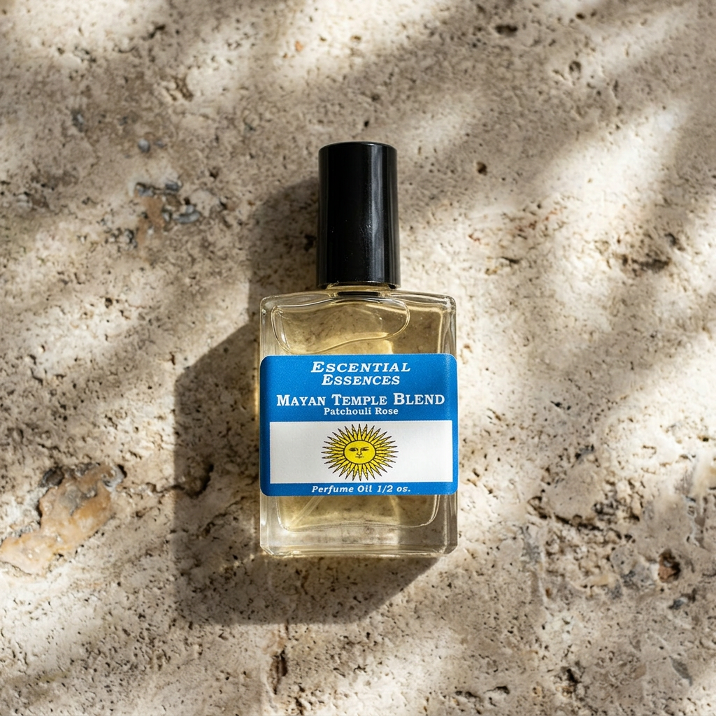 Top-down shot of the Mayan Temple perfume oil bottle on a stone countertop, emphasizing transparency, texture, and ambient natural lighting.