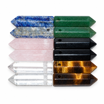 Twelve assorted crystal points on a plain white background