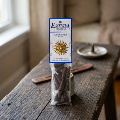 Close-up of a petite white lotus incense cone on dark wood, highlighting micro-texture and subtle white hue with natural daylight.