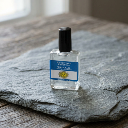 Close-up of 1/2oz white sage essential oil bottle on natural stone, showcasing glossy glass and white label with earthy wooden background.