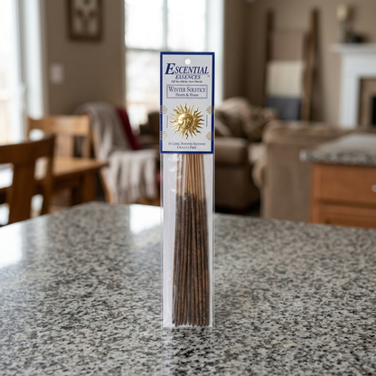 Detailed full-body shot of Winter Solstice incense pack on granite countertop in inviting living room with natural daylight.
