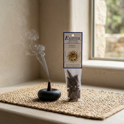 Small Nirvana Incense Cone in sleek holder on a textured mat in a Zen-inspired room with greenery, ideal for mindfulness and space cleansing.